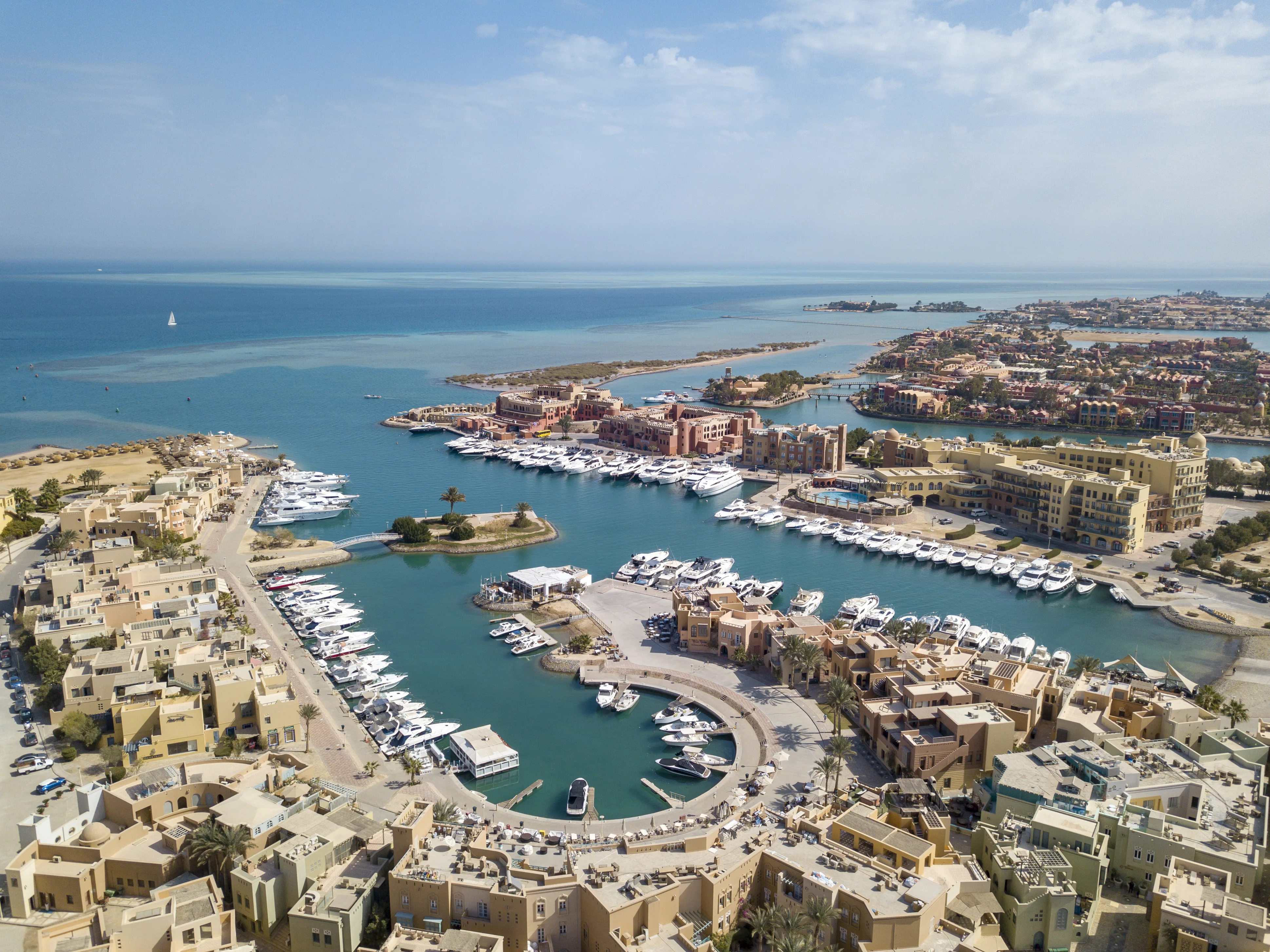 Aerial photograph of Abu Tig Marina in El Gouna, Egypt, with yachts and Red Sea waterfront architecture